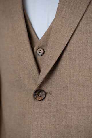 Brown Quesste extended suit with a vest