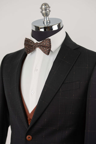 Black Quesste extended suit with plaid pattern and a brown vest