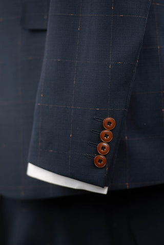 Dark blue Quesste extended suit with plaid pattern and a brown vest