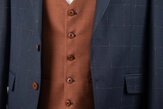 Dark blue Quesste extended suit with plaid pattern and a brown vest