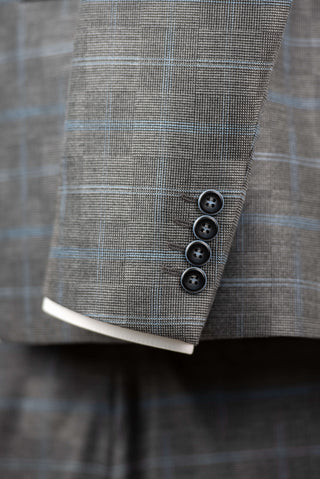Grey Quesste extended suit with a vest and a light blue plaid pattern