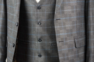 Grey Quesste extended suit with a vest and a light blue plaid pattern