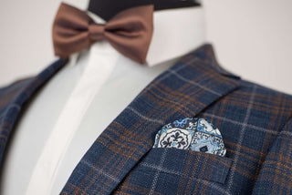 Blue Quesste extended suit with a vest and brown, grey plaid pattern