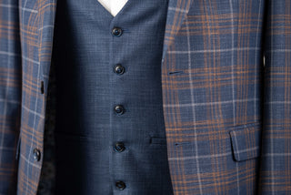 Blue Quesste extended suit with a vest and brown, grey plaid pattern