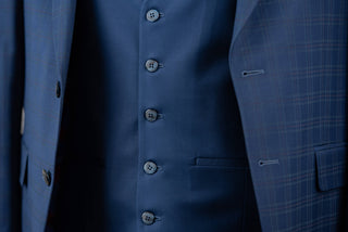 Blue Quesste extended suit with a vest and a soft plaid pattern